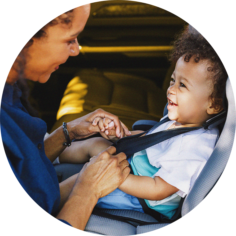 mom helping young child in car seat mom helping young child in car seat